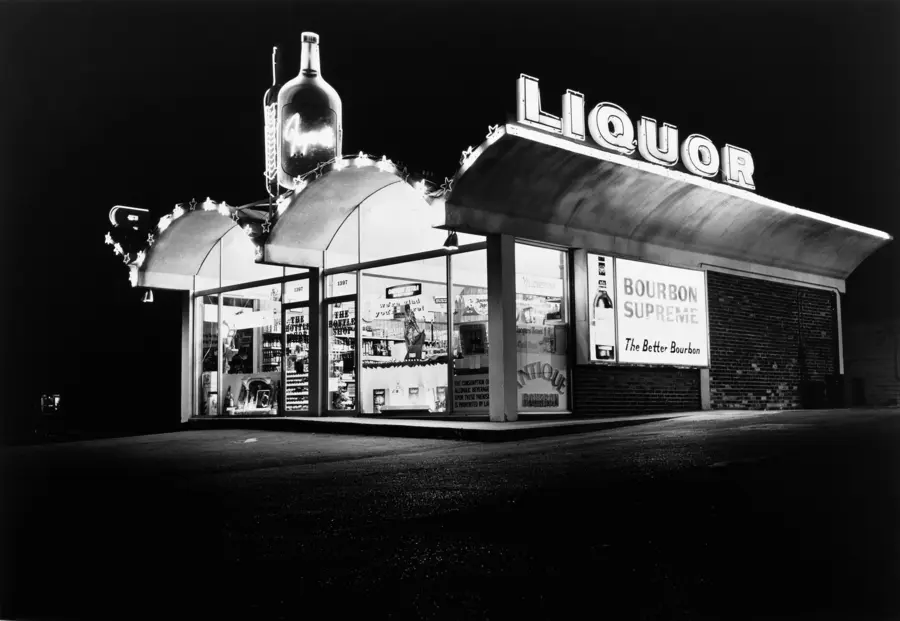 Black and white photograph of the outside of a liquor store.