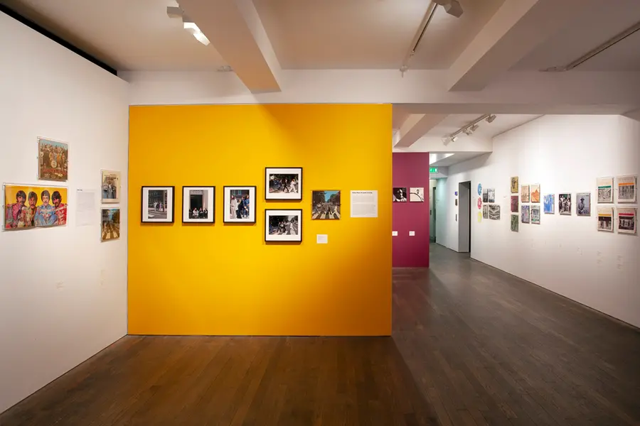 Yellow wall displaying test shots for the beatles abbey road album 