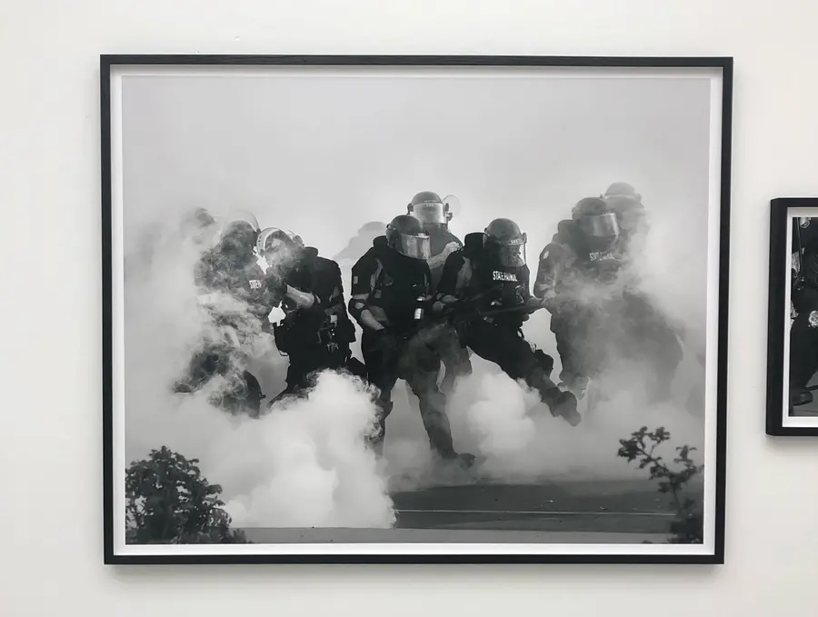 american police in riot gear surrounded by fog