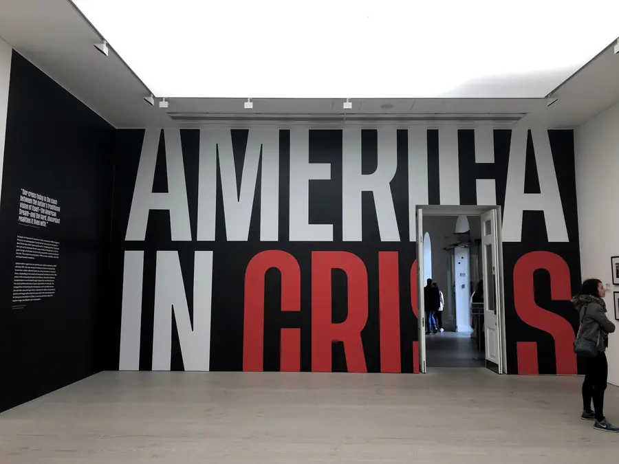 Image of exhibition opening, title in large letters 