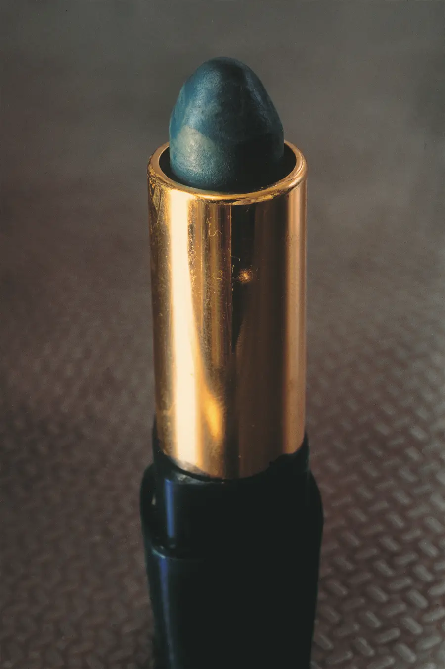 Colour photograph of a blue lipstick.
