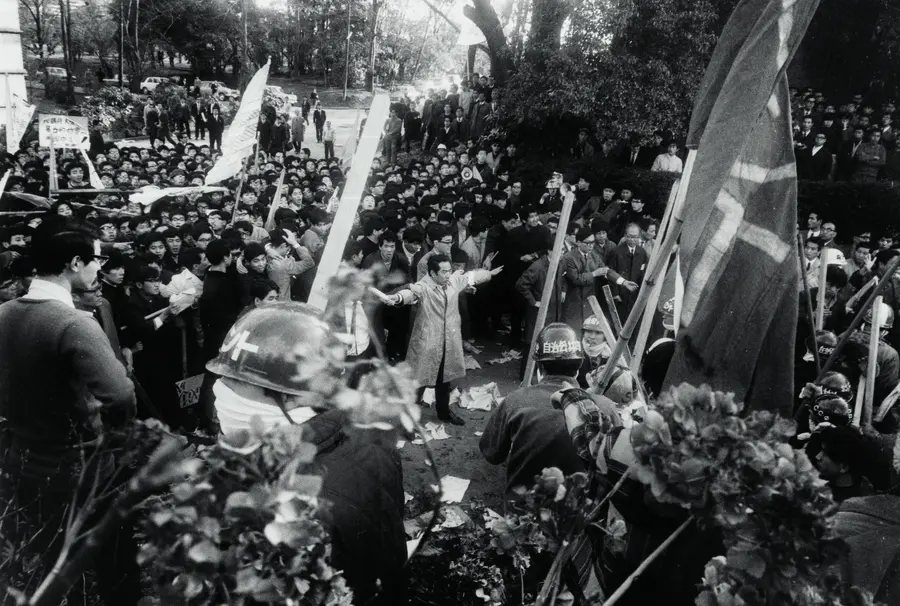 Black and white photograph of a crowded  demonstration taking place.