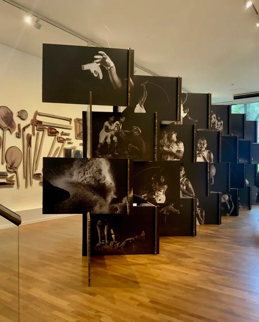 Close up of the centre of the room, prints suspended criss-cross in the centre of the room