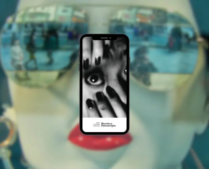 Colour image of a phone screen showing the digital guide with a colour photograph of a mannequin in the background