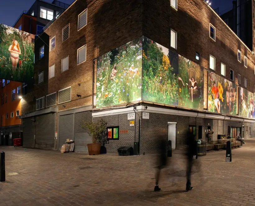 Large format prints of garden scenes displayed on the side of a building.