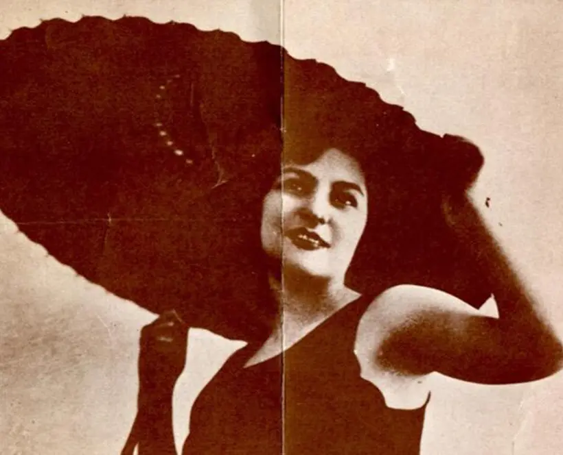 Original exhibition poster showing a woman in a swimming costume with a parasol