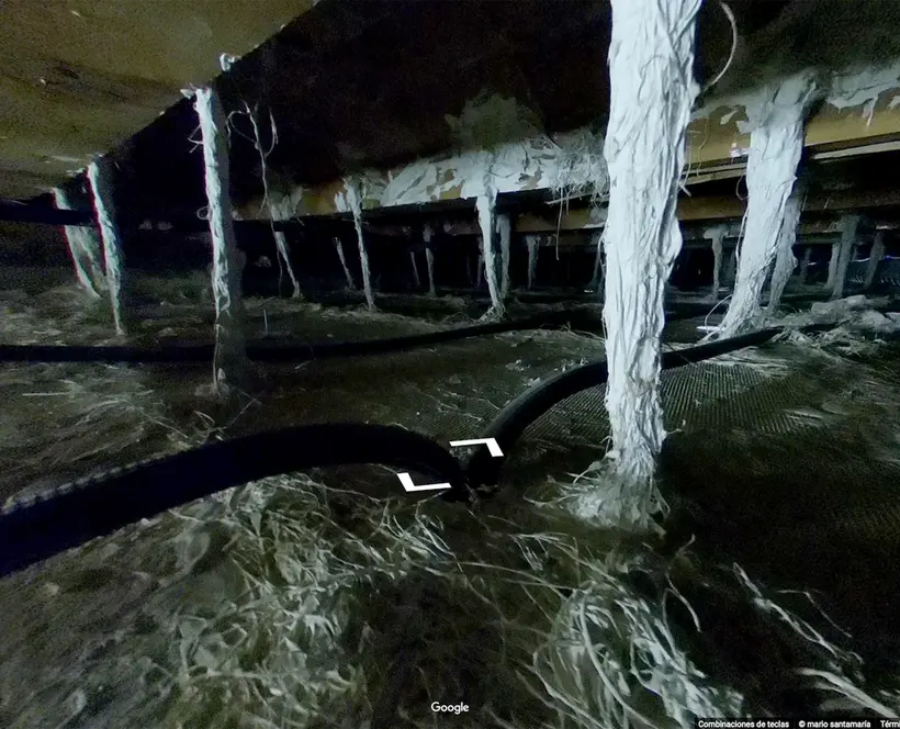 A screen capture of Google Street View showing cables and other infrastructure behind a wall 
