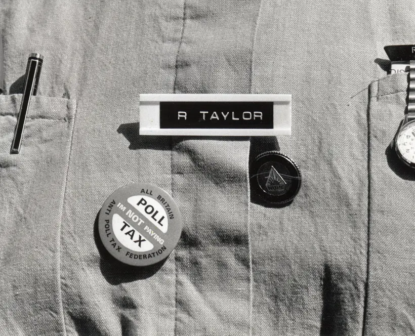 A nurses uniform including a Poll Tax badge