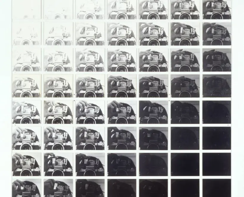 Grid of replicated black and white images of a camera, going from white to black