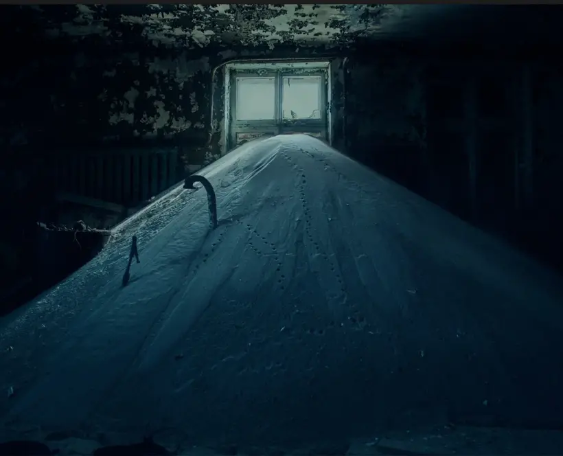 Mound of snow held indoors with small window in background