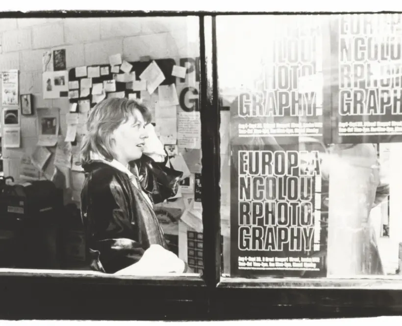 Sue Davies, founding director of The Photographers' Gallery, pictured with New European Colour photography posters, 1978. Photographer unknown