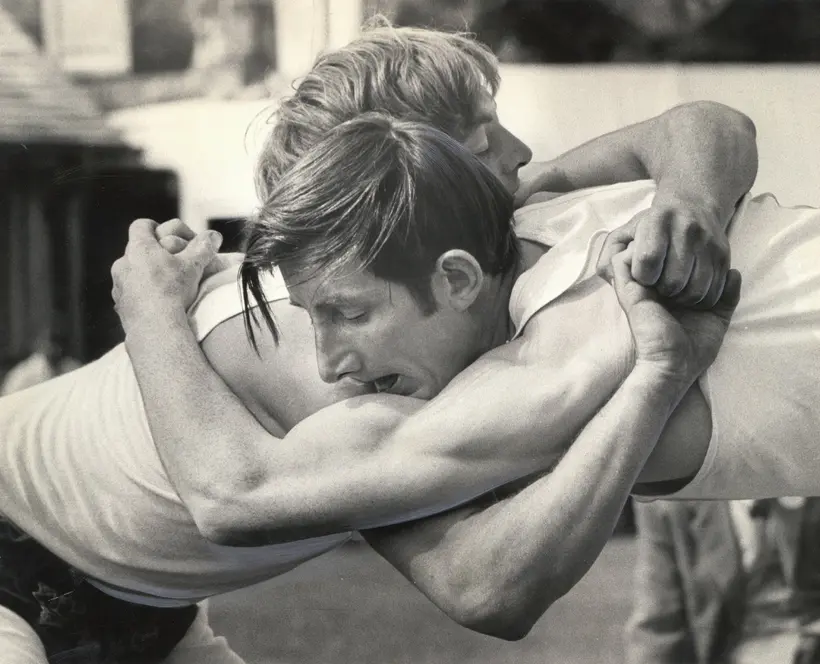Photo of two white men wrestling in black and white