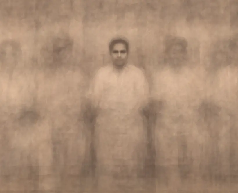A composite of several sepia close-up photographs of a group of people posing in a South Asian photo studio. The image is ghostly other than the person in the centre's face.