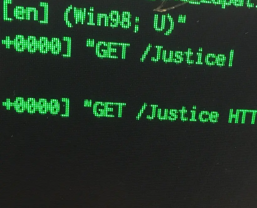 Close up of a screen with the "Get / Justice" text on it