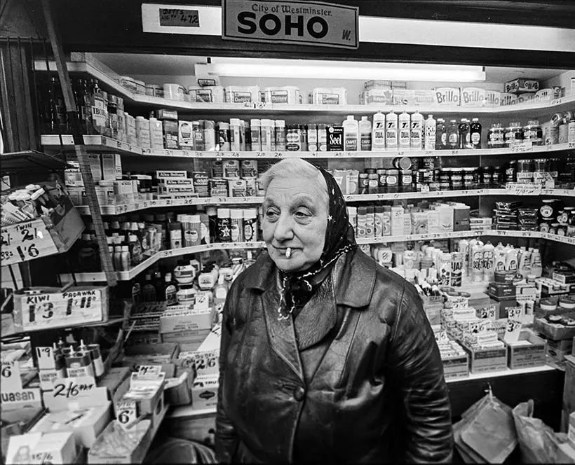 Black and white photo of a woman in a tobacconist