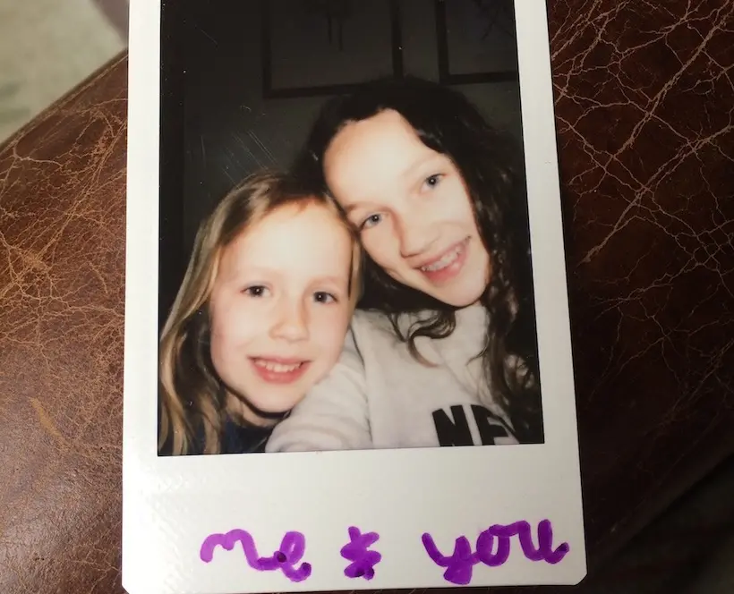 A Polaroid Selfie of the Photographer's Oldest and Youngest Daughters