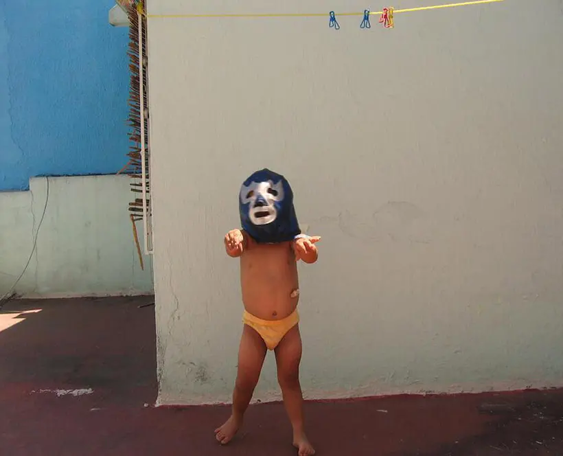 A child in a wrestling mask