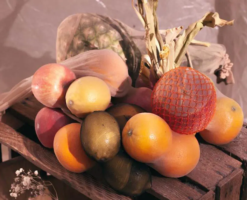 Fruit in the top of a wooden crate.
