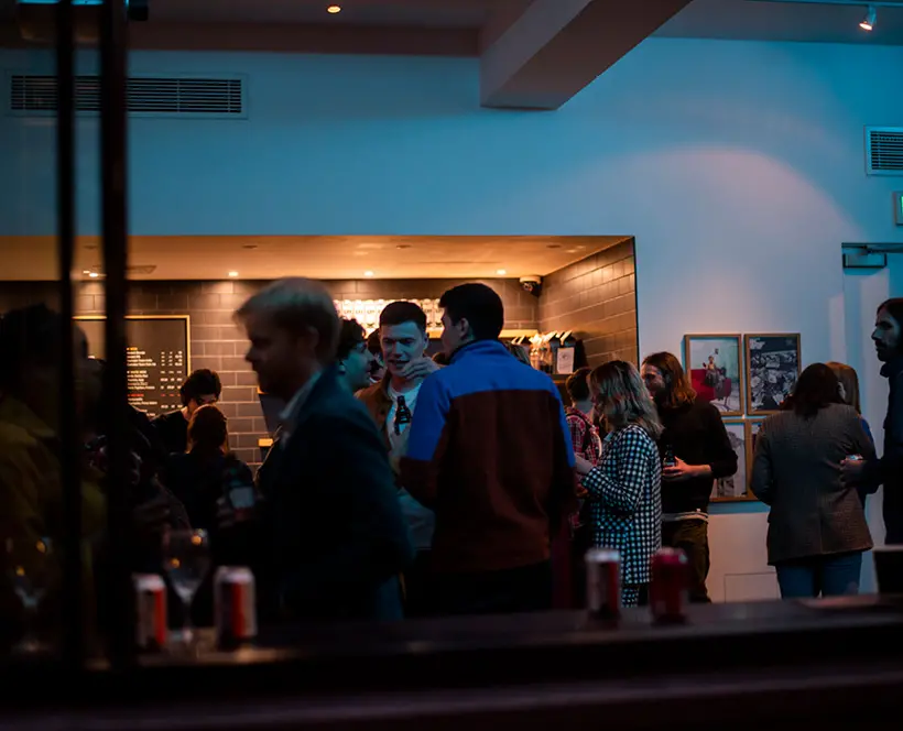 Group of people enjoying drinks at The Photographers Gallery's café bar