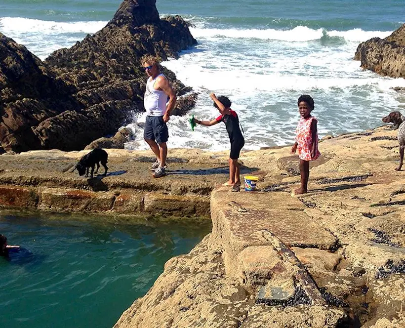 The photographer's family frolics on the rocky shore of her favourite beach from childhood